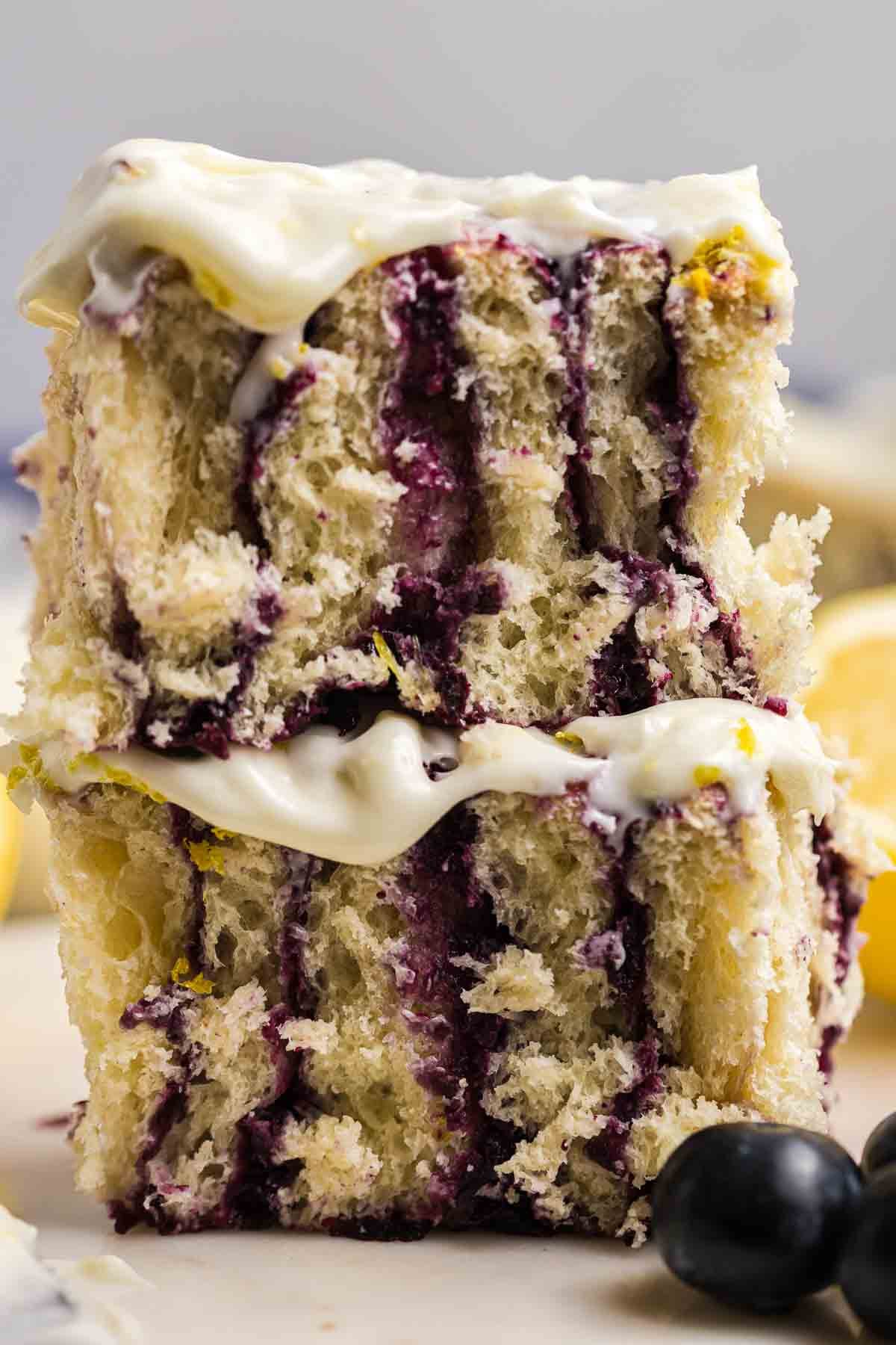 Two lemon blueberry rolls stacked on top of each other.