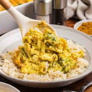 A plate of chicken divan casserole served over rice.