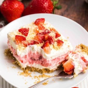 A plate with a slice of strawberry delight.