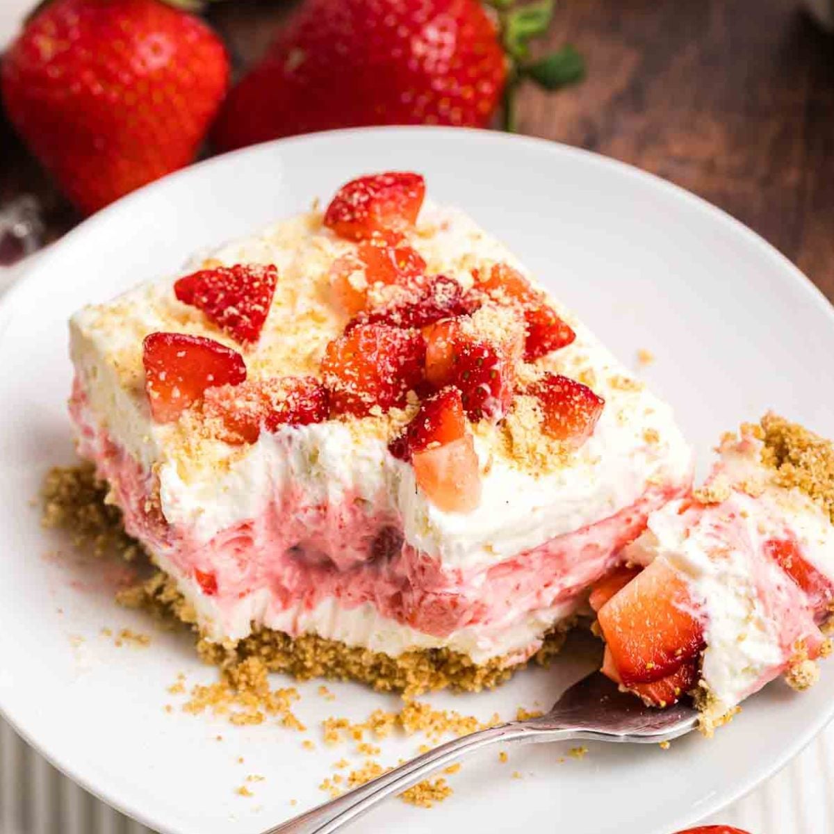 A plate with a slice of strawberry delight.
