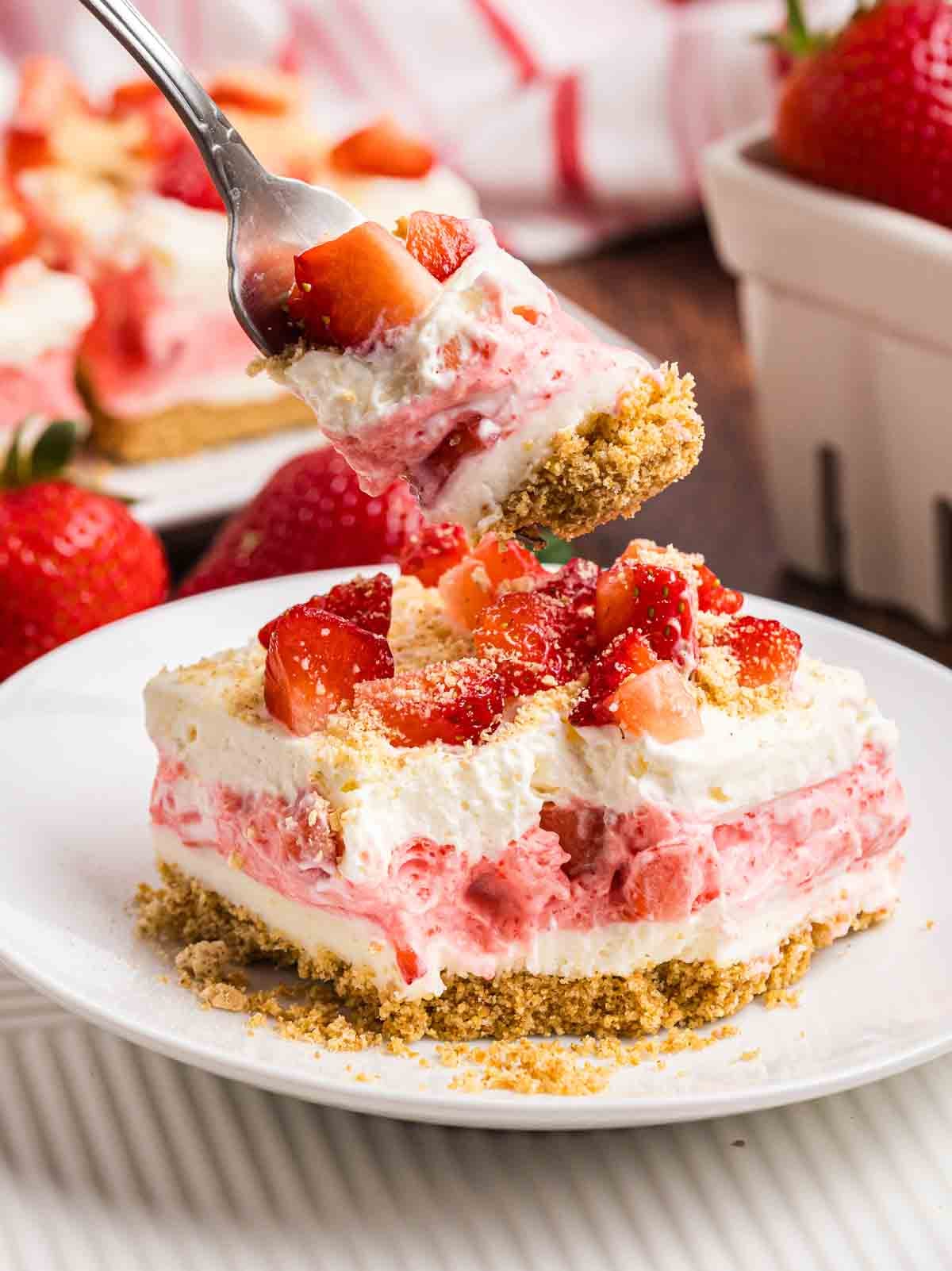 Taking a forkful of strawberry delight.