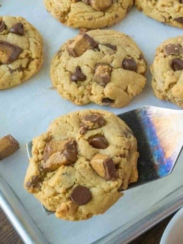Close up of a peanut butter cup cookie on a spatula.