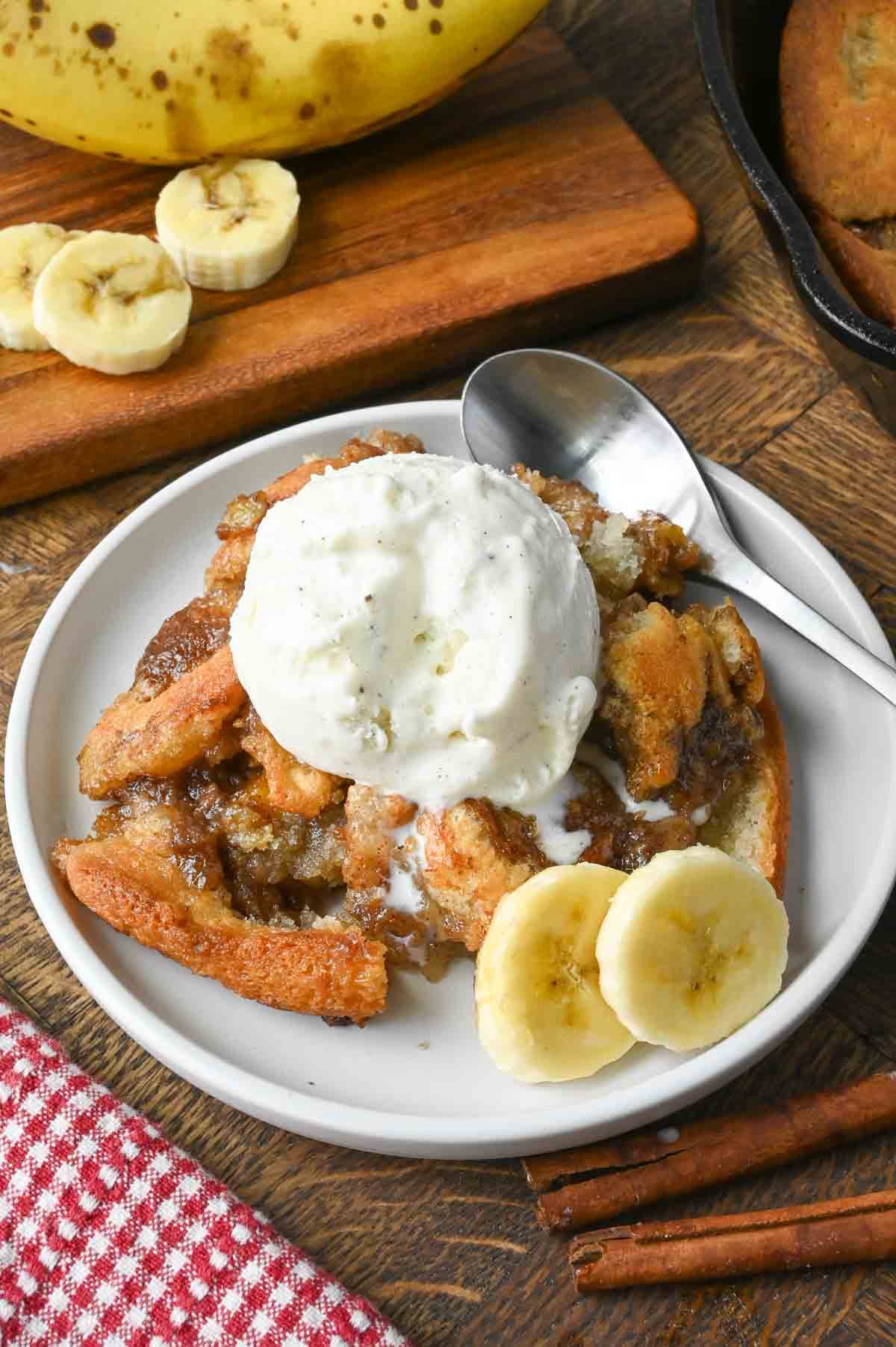 A plate of old fashioned banana cobbler with ice cream.