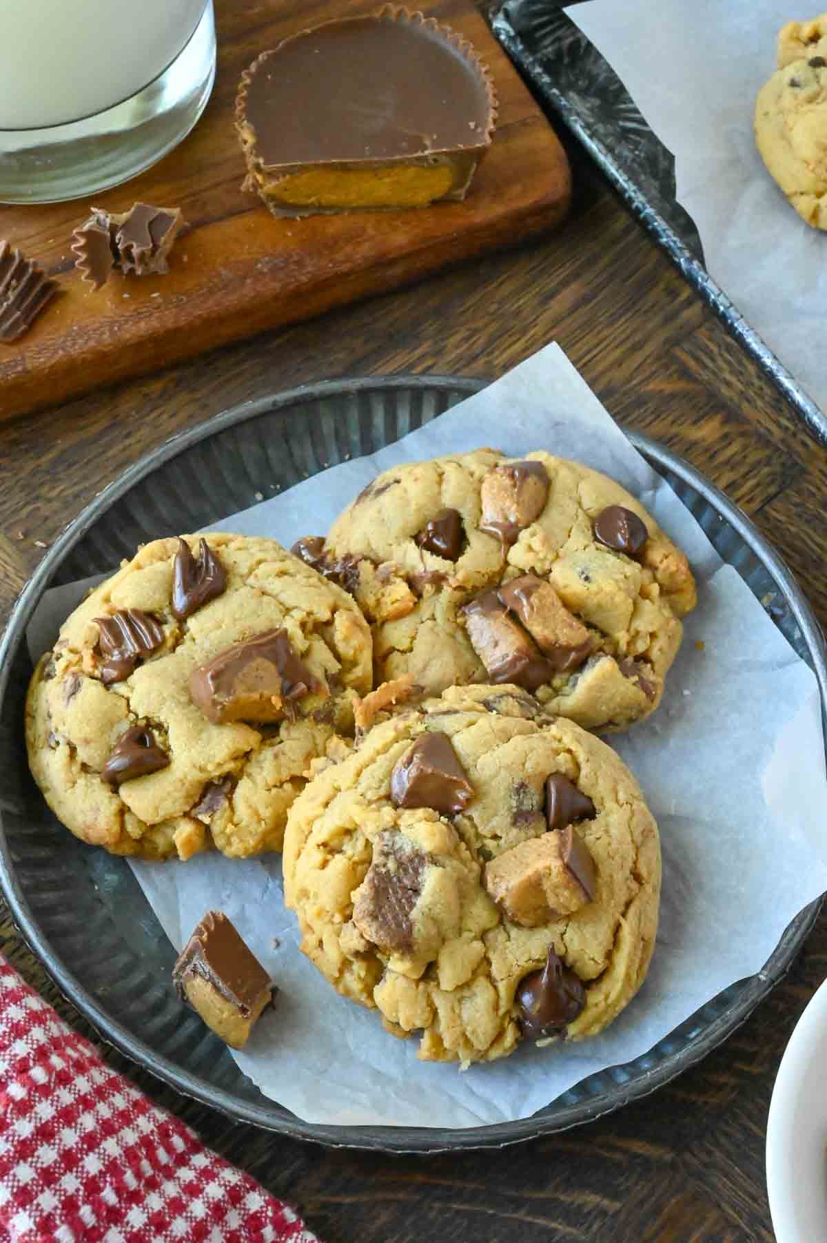 Three peanut butter cup cookies on a plate.