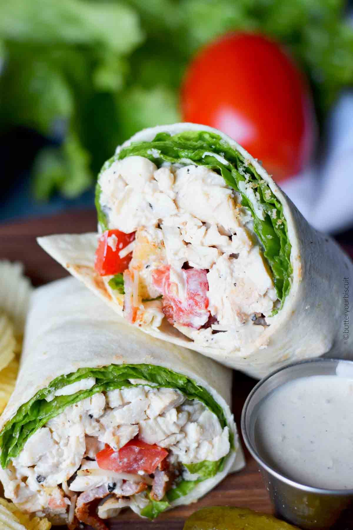 Chicken Caesar salad wrap on a cutting board.