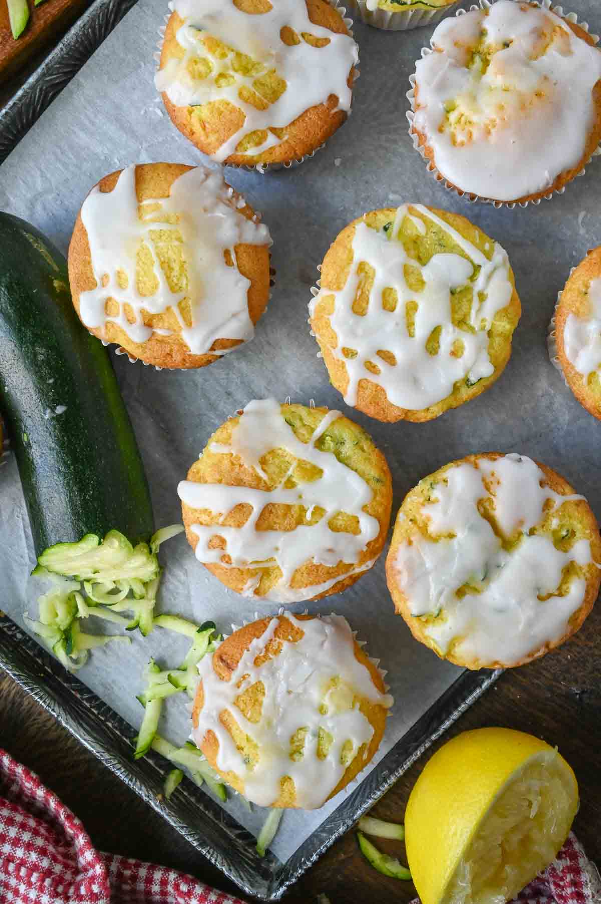 A tray of lemon zucchini muffins with icing.
