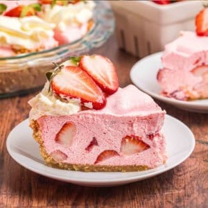 A slice of no bake strawberry cool whip pie on a plate.