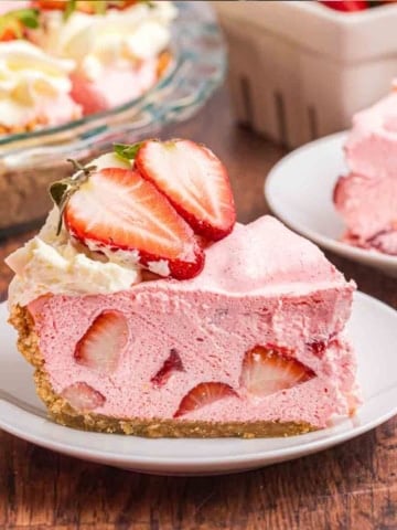 A slice of no bake strawberry cool whip pie on a plate.