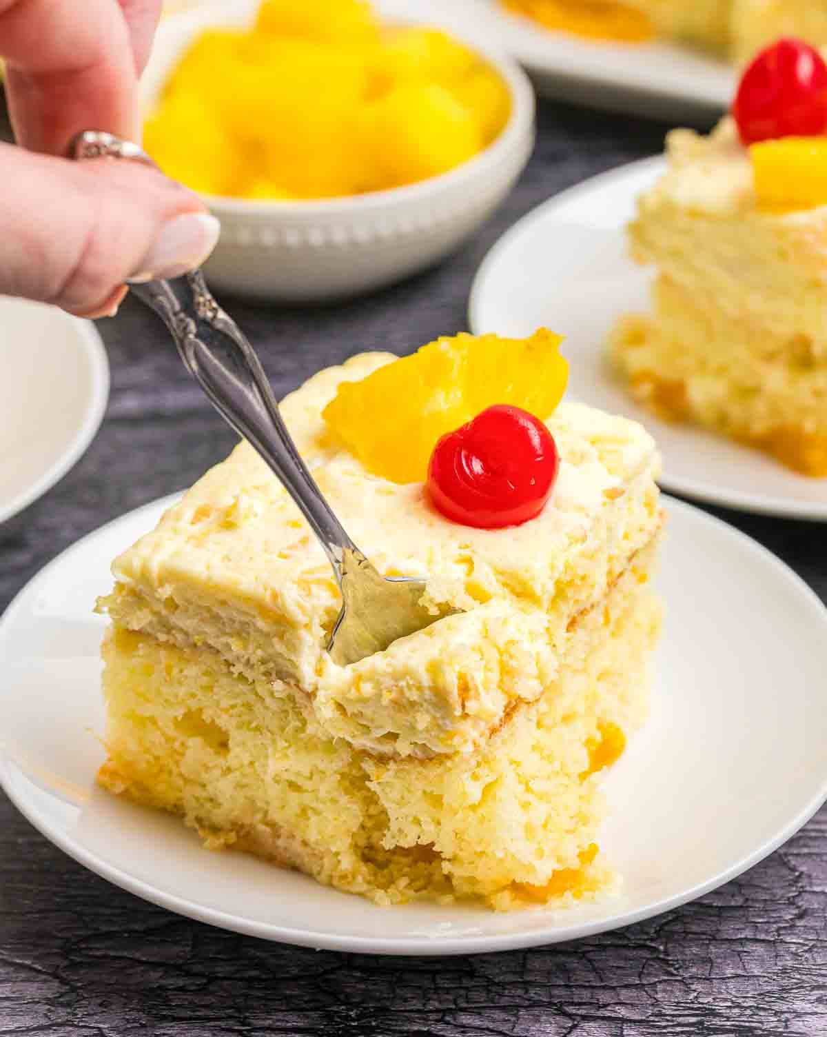 A plate with a slice of sunshine cake and a silver fork.