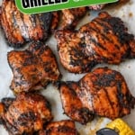 sweet n spicy grilled chicken thighs on a baking sheet pinterest pin.