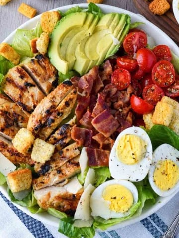 Close up of a plate of grilled chicken caesar salad.