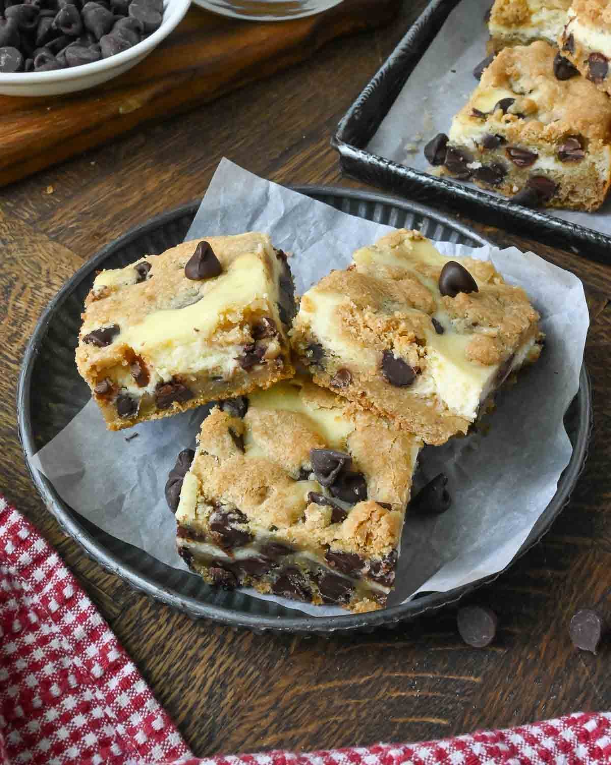 A plate with 3 cookie cheesecake bars.