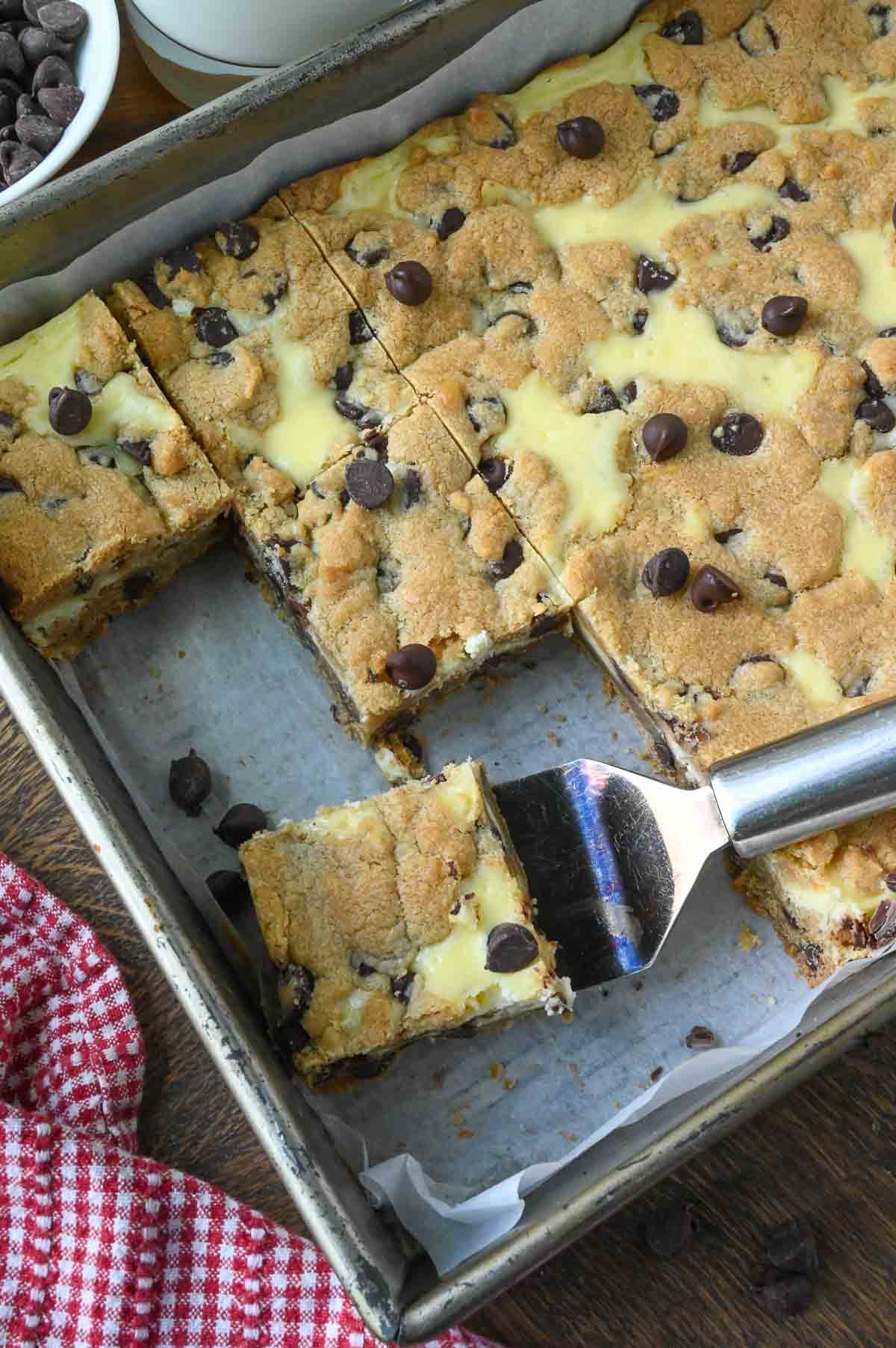 A baking tray with chocolate chip cheesecake bars.