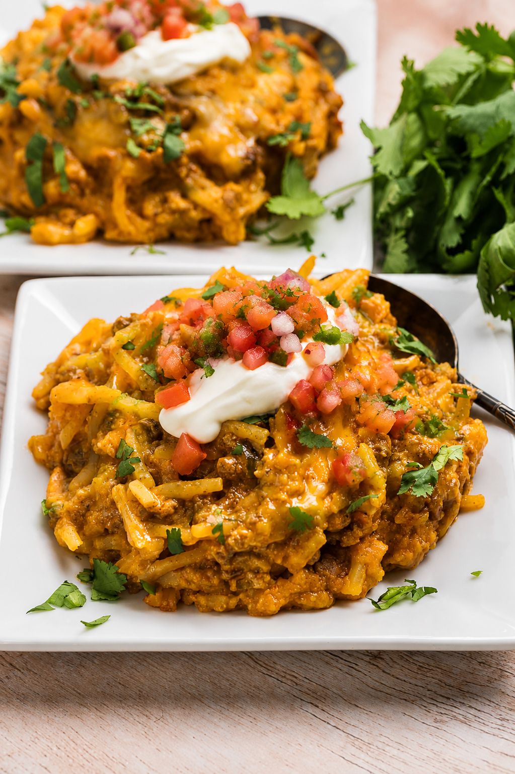 A plate of slow cooker taco casserole garnished with cilantro.