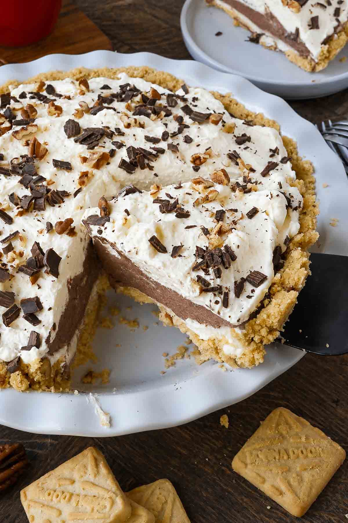Taking a slice of possum pie from a pie tin.