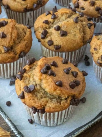 Easy peanut butter banana muffins on a parchment paper lined baking sheet.