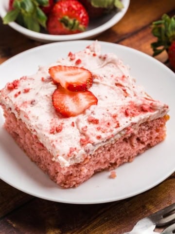 A close up of a slice of strawberry sheet cake on a plate.