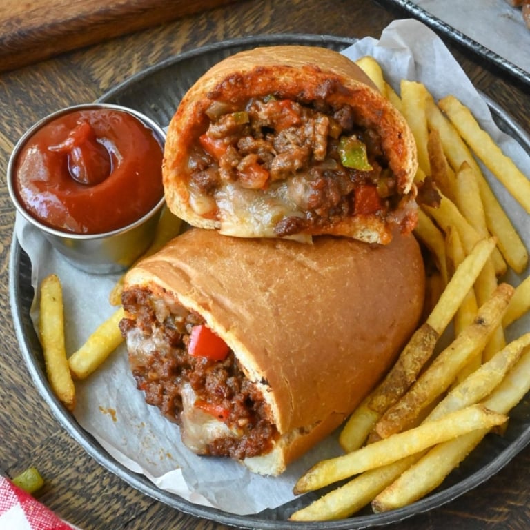 Sloppy joe stuffed rolls in a basket of french fries.