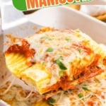 A spatula scooping up some four cheese manicotti.