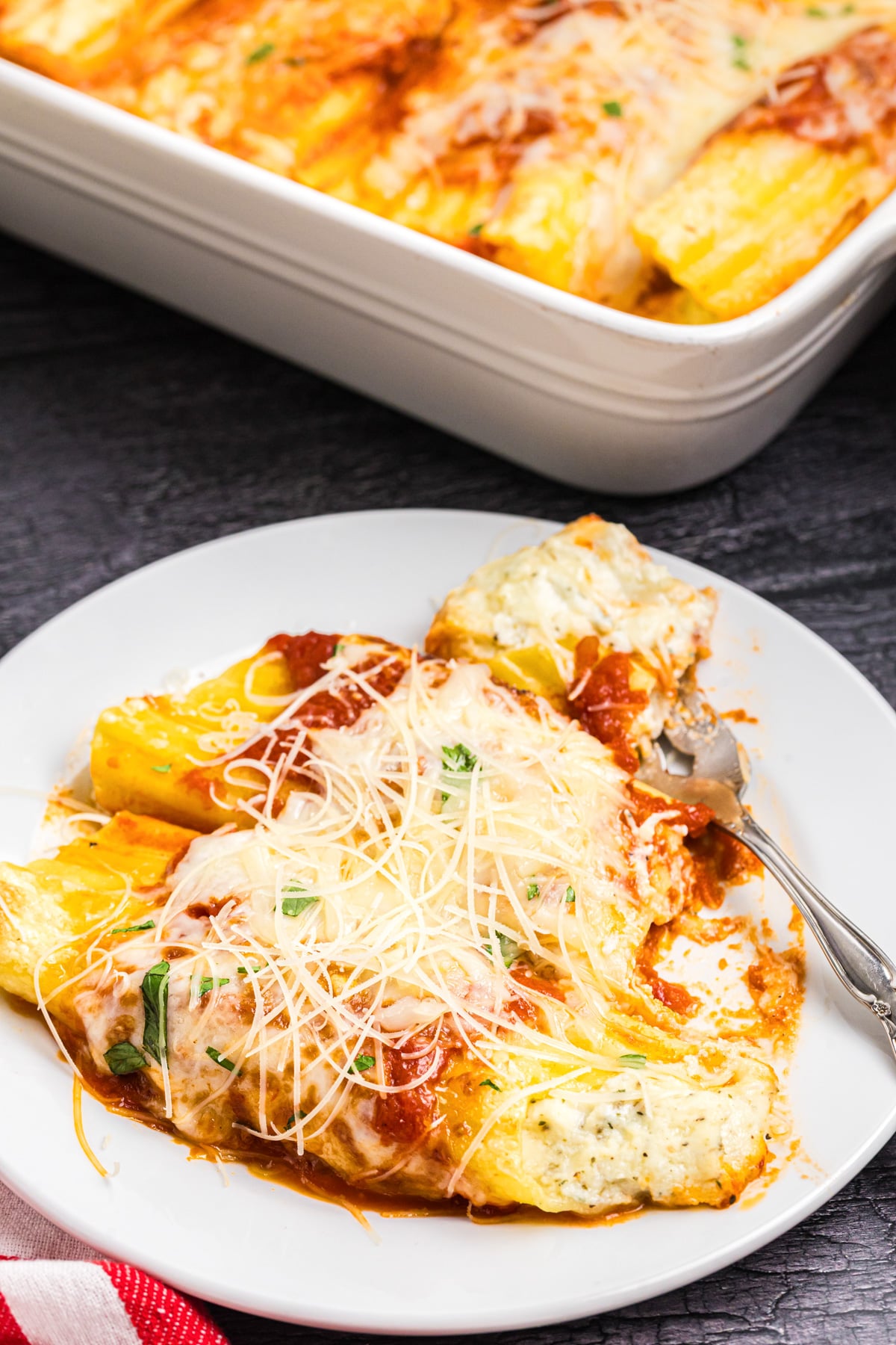 Four cheese manicotti on a plate.