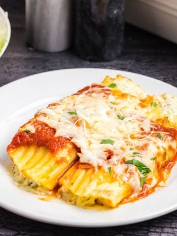 Four cheese manicotti on a plate.