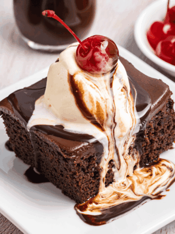 Cracker barrel coca cola cake on a plate with ice cream on top.
