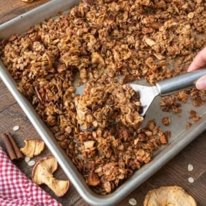 Baked apple pie granola on a baking sheet.