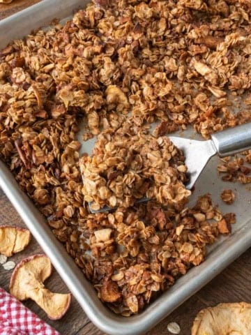 Baked apple pie granola on a baking sheet.
