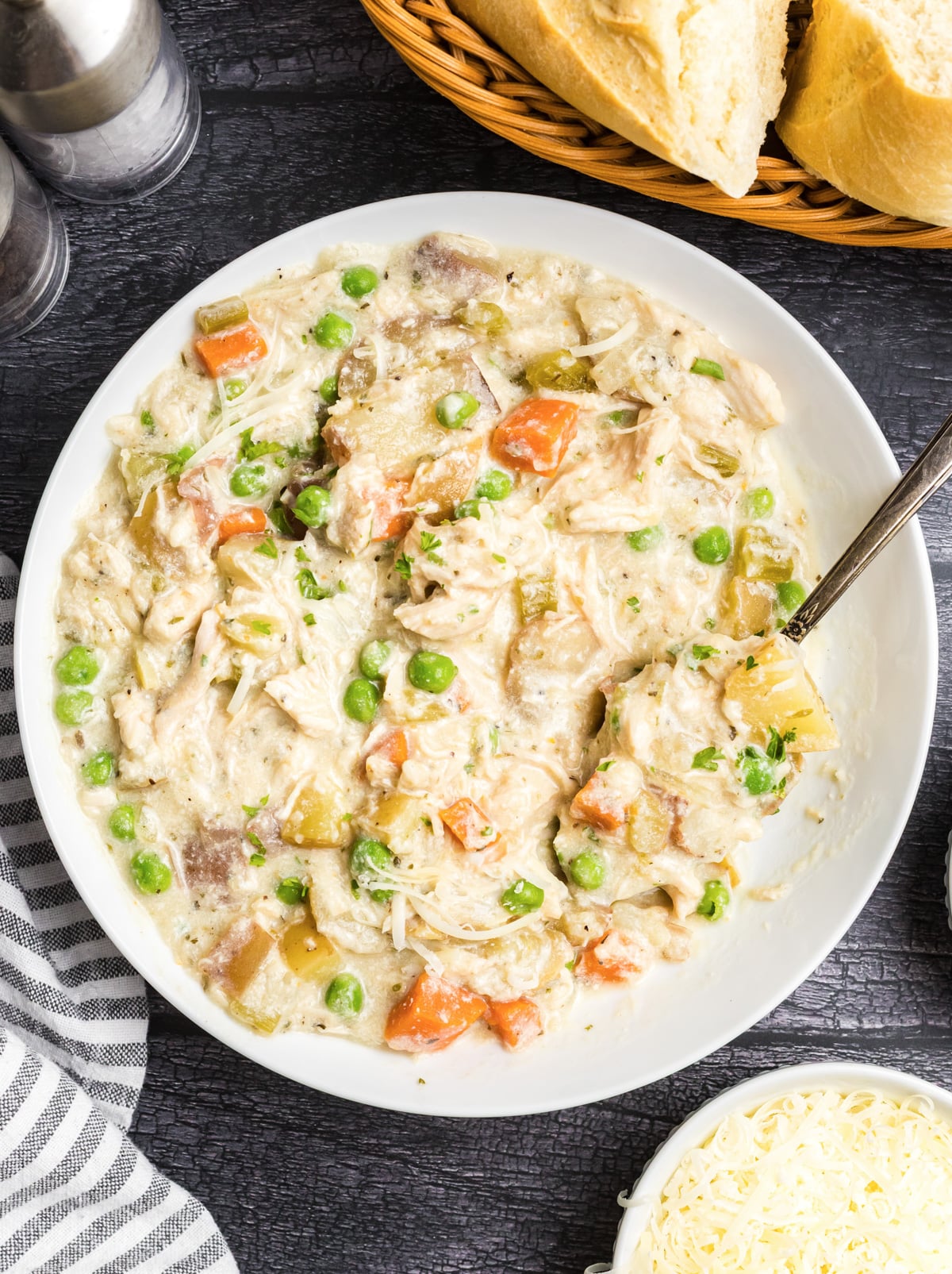Slow cooker parmesan chicken stew in a white bowl.