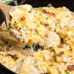 Olive Garden Ravioli Carbonara in a cast iron skillet with a wooden spoon.