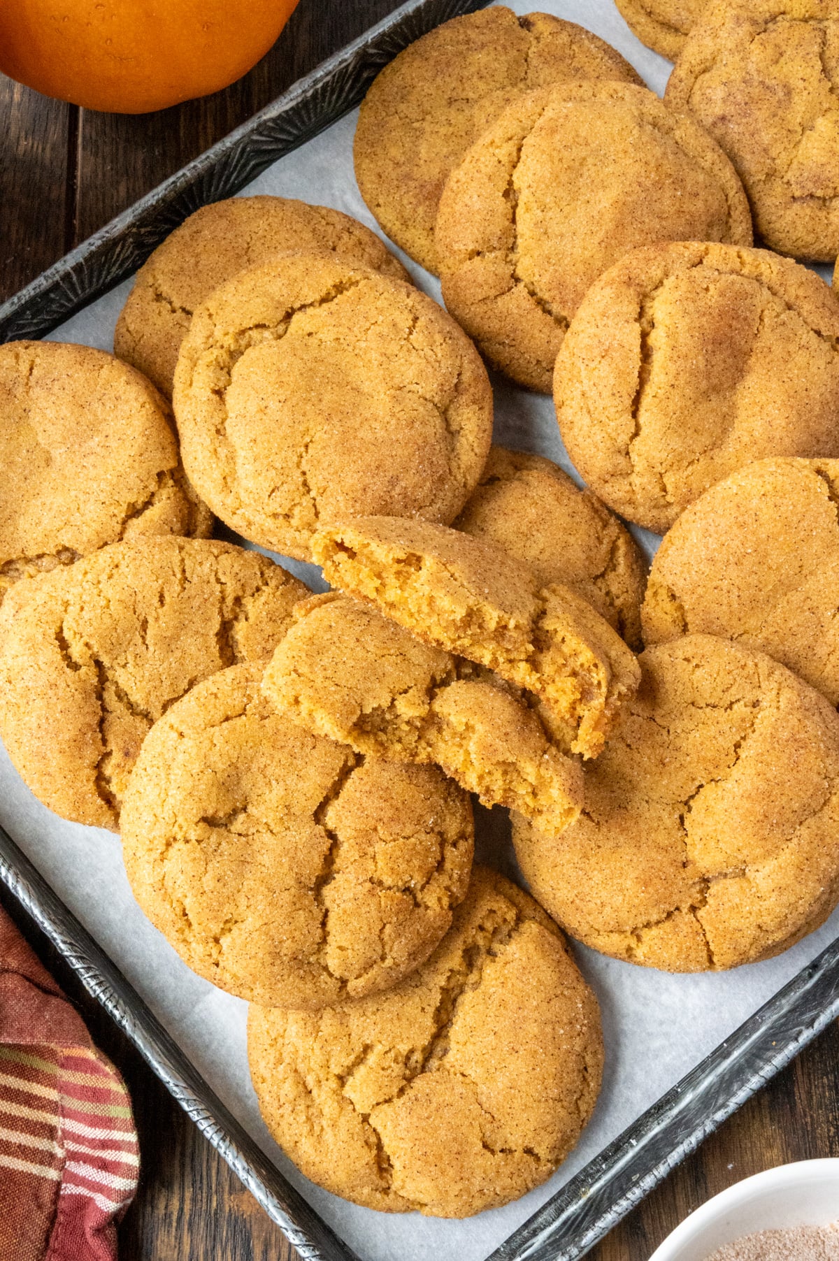 Pumpkin snickerdoodles cookies on a baking sheet.